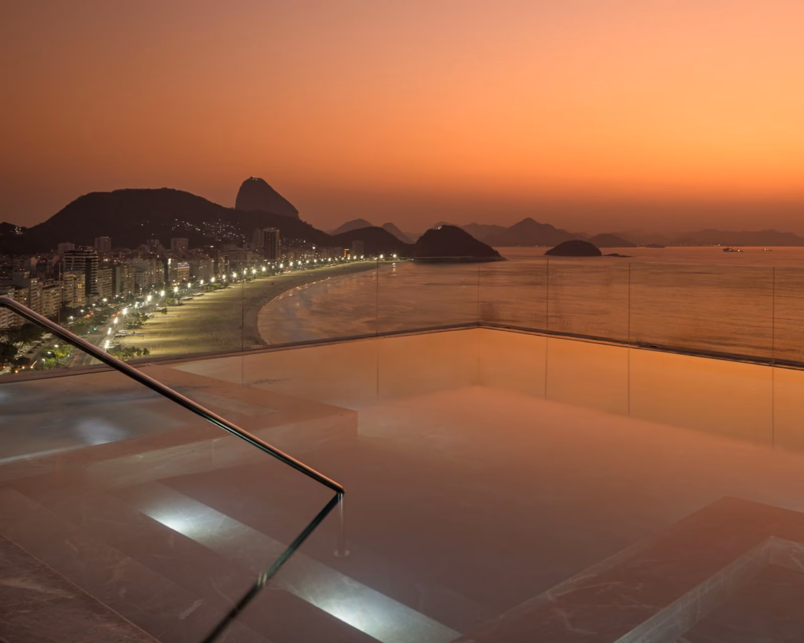 Rooftop pool and terrace above Copacabana at sunset