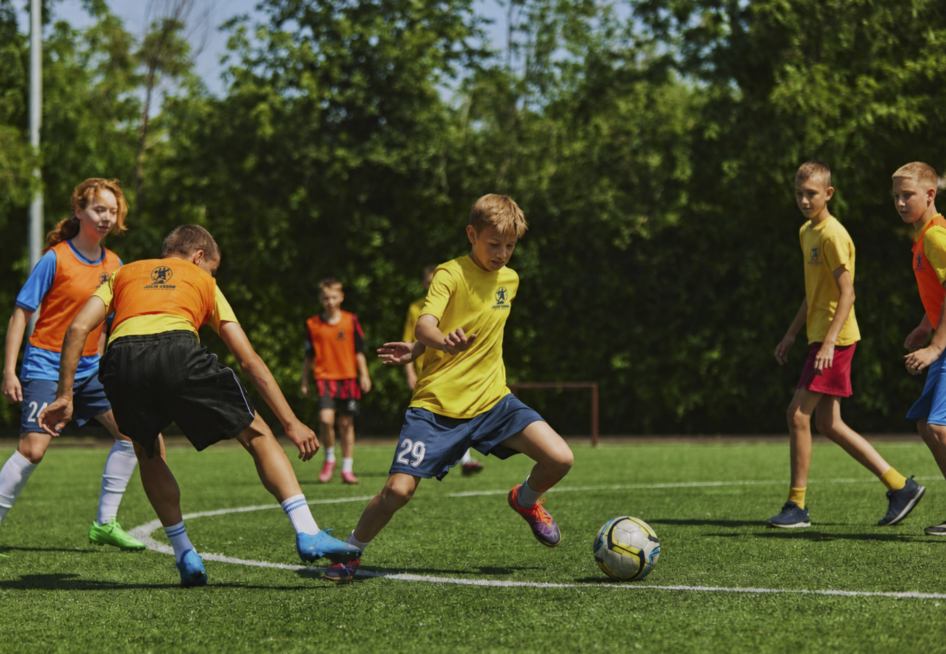 A player taking on defenders in a competitive small-sided game
