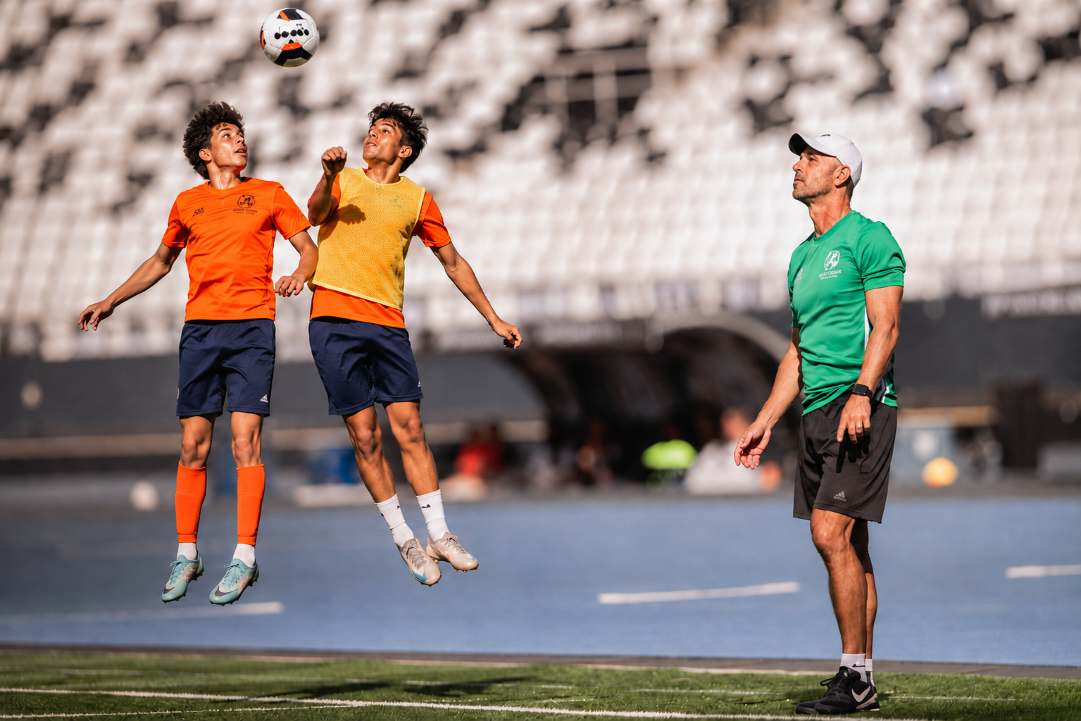 Julio watching two players contest a header during a focused session